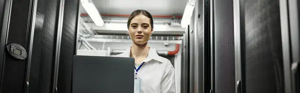 A dedicated IT specialist works diligently with server hardware in a contemporary data center, banner — Stock Photo