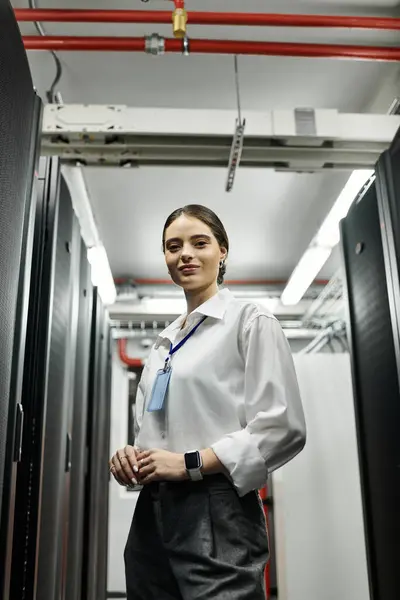An IT specialist in a white shirt skillfully manages network systems in a data center. — Stock Photo