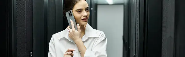 A woman in a white shirt is engaged in IT work inside a sophisticated server room, banner — Stock Photo
