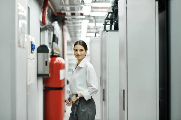 A professional woman in a white shirt works hard in the server room, ensuring network security. — Stock Photo