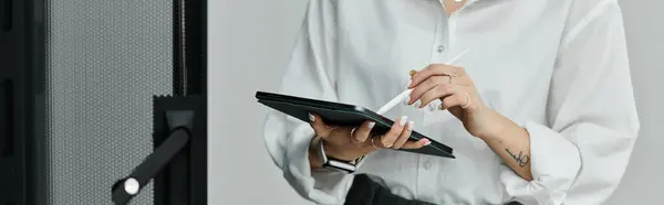 A woman in a white shirt is working diligently in a state-of-the-art server room, banner — Stock Photo