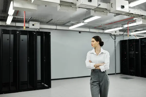 A qualified IT specialist in a white shirt efficiently oversees server operations. — Stock Photo