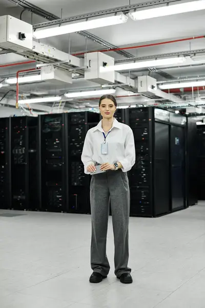 A woman in a white shirt works hard in a busy server room, keeping systems running smoothly. — Stock Photo