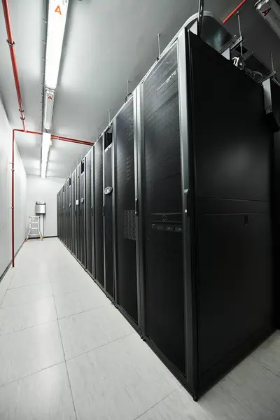 A professional data center features rows of server hardware in a sleek, modern setup. — Stock Photo
