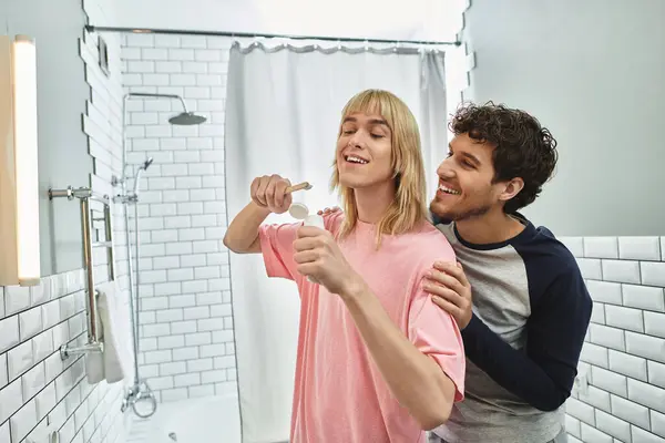 A cheerful moment unfolds as two men enjoy their morning routine, brushing teeth together. — Stock Photo
