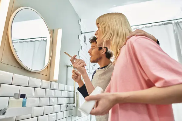 Two men joyfully engage in their morning routine while getting ready together in the bathroom. — Stock Photo