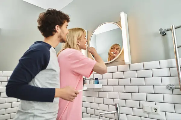 Two men happily brush their teeth together in the morning. — Stock Photo
