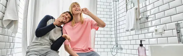 Two loving partners share laughter and affection in their stylish bathroom during morning routines. — Stock Photo
