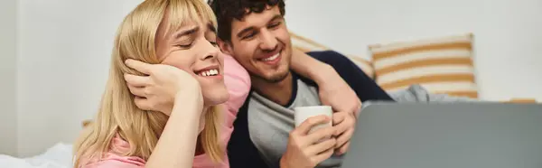 Two men share laughter and warmth together on a relaxing evening at home, creating special memories. — Stock Photo