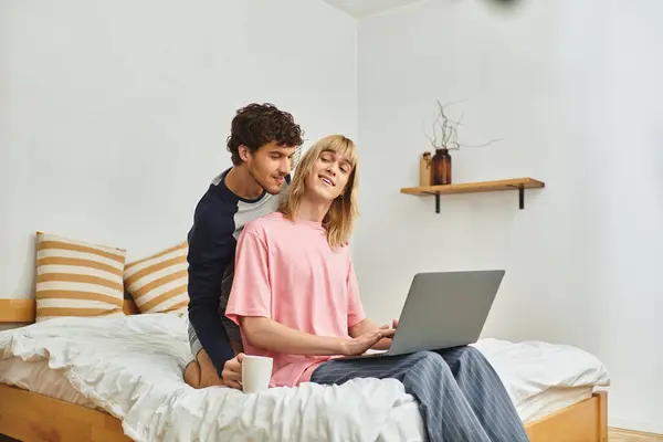Two men share a tender moment while supporting each other in a bright, inviting space. — Stock Photo