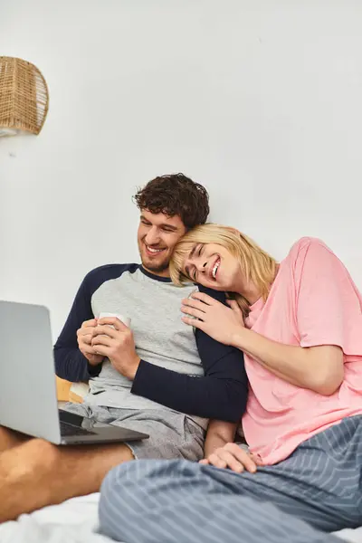 Two men share laughter and warmth while relaxing together in their cozy living space. — Stock Photo