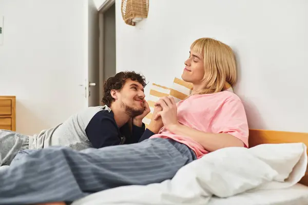 Two gay men share a tender moment in their serene bedroom, expressing deep affection and joy. — Stock Photo