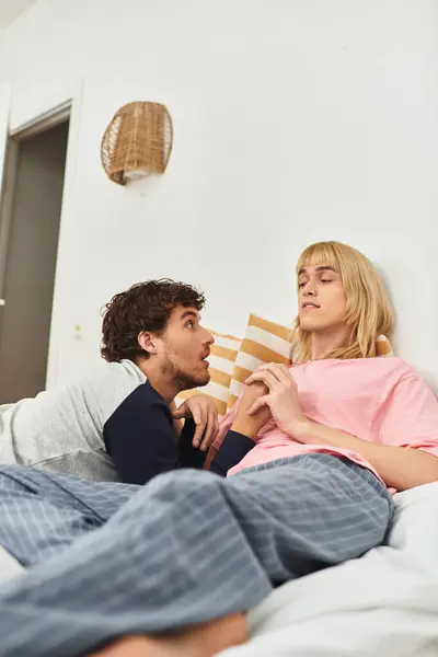 Two men comfortably interact in a cheerful bedroom, radiating love and connection between them. — Stock Photo