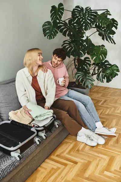 Two vibrant men share a moment of laughter while packing for their journey together. — Stock Photo