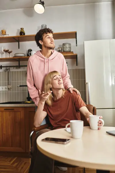 Two men enjoy a loving moment in their cozy, modern kitchen. — Stock Photo
