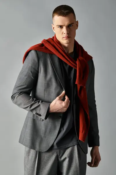 Young man shows off modern fashion with a mix of elegance and casual charm during a photoshoot. — Stock Photo