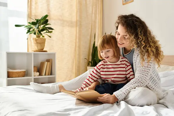 A joyful mother and daughter share quality time reading together in a sunny, comfortable bedroom. — Stock Photo