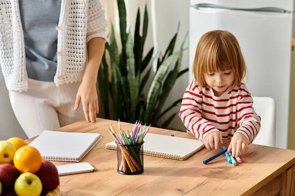 Modern parenting shines as a mother and daughter engage in colorful art and playtime. — Stock Photo