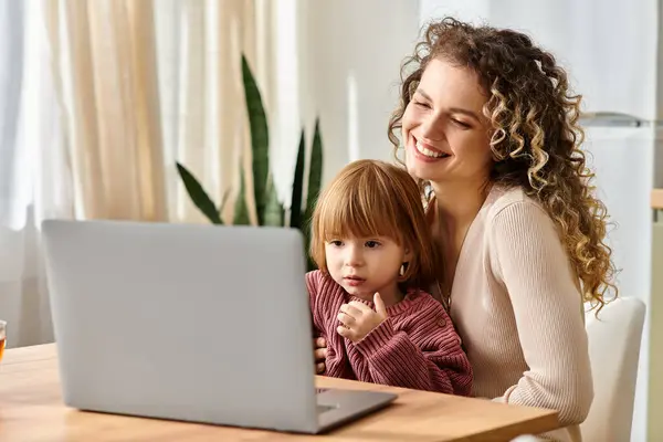 Mother and daughter happily engage with a laptop, enjoying quality time at home together. — Stock Photo