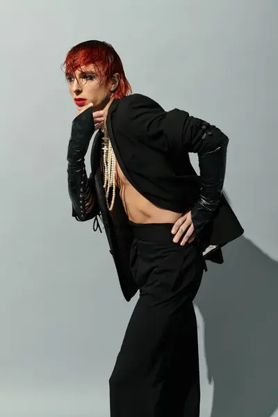 Confident young man with red hair showcases bold, dramatic fashion choices. — Stock Photo