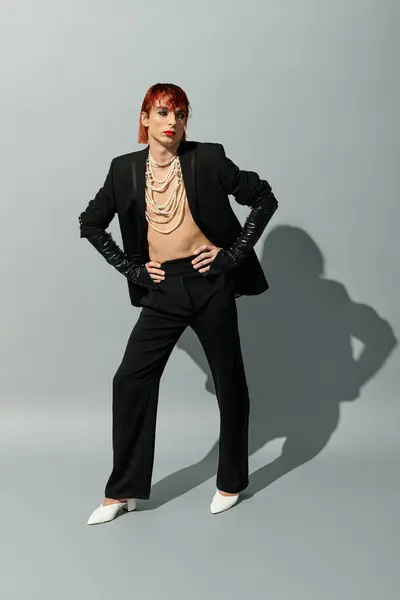A confident young man showcases his unique style in a fashionable blend of elegance and edge. — Stock Photo