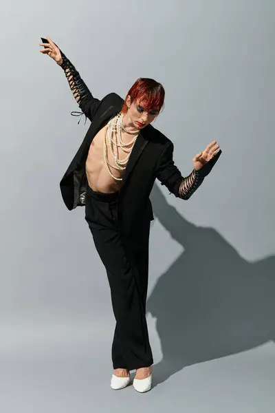 A striking young man in a bold outfit strikes an artistic pose, radiating confidence and flair. — Stock Photo