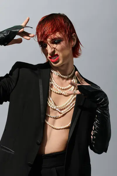 A young man with a unique style poses dramatically, exuding confidence and artistic flair. — Stock Photo