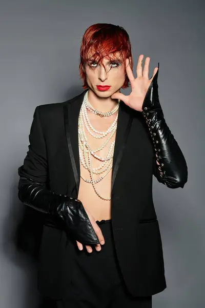 A unique young man boldly showcases a playful fashion statement against a minimal backdrop. — Stock Photo