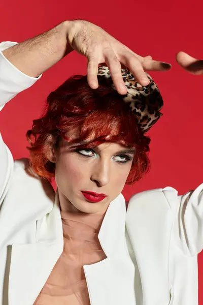 A striking young man with red hair expresses artistic flair while wearing a stylish hat. — Stock Photo