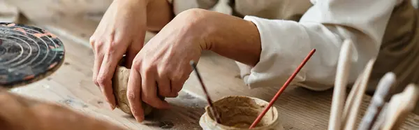 Mature woman enjoying her quality time while shaping clay in a pottery class, banner — Stock Photo