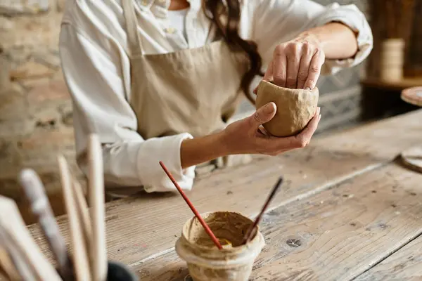 Cropped woman works on shaping clay, enjoying pottery class experience. — Stock Photo
