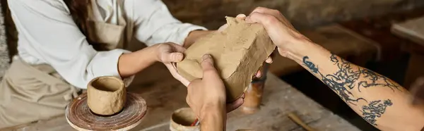 A couple shapes clay together in a pottery class, deepening their bond and creativity, banner — Stock Photo
