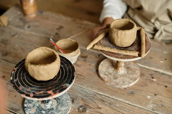 Shaping clay in a pottery class, fostering creativity and connection. — Stock Photo