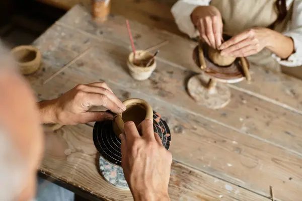 Cropped couple enjoys a pottery class, shaping clay and sharing quality moments together. — Stock Photo