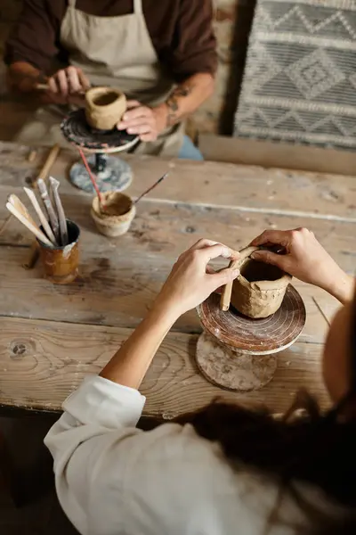 Couple of middle age shares quality time shaping clay in a pottery class. — Stock Photo