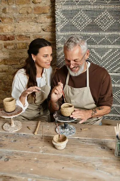A couple deepens their bond while sharing joyful moments in a pottery class. — Stock Photo