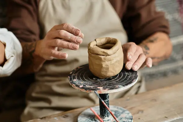 A middle-aged couple enjoys quality time shaping clay in a pottery class. — Stock Photo