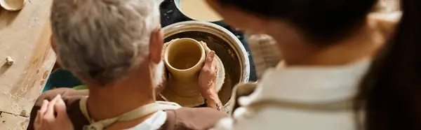 A beautiful couple enjoys shaping clay together in a pottery class, sharing quality time, banner — Stock Photo