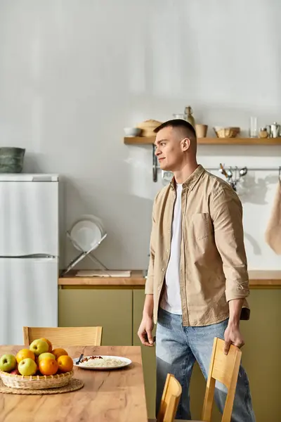 A handsome young man enjoys a simple life in his modern apartment. — Stock Photo