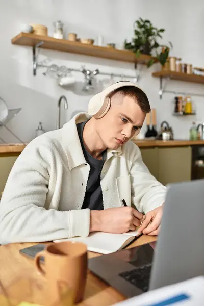 Young man in casual attire is deeply engaged in remote work at his stylish apartment. — Stock Photo