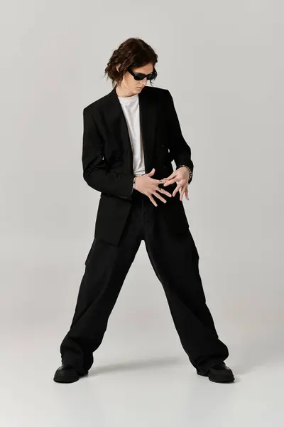 Handsome young man showcases his unique style with a bold outfit and cool sunglasses. — Stock Photo