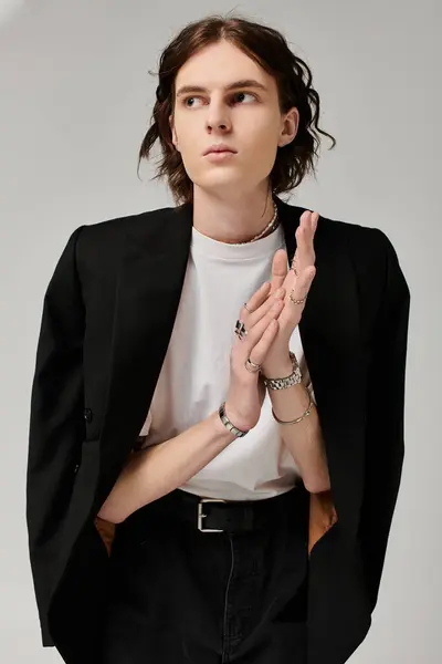A stylish young man embodies confidence in a chic, minimalist setting. — Stock Photo
