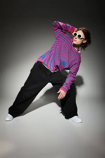 Confident young man showcases unique fashion sense with bold colors and striking sunglasses. — Stock Photo