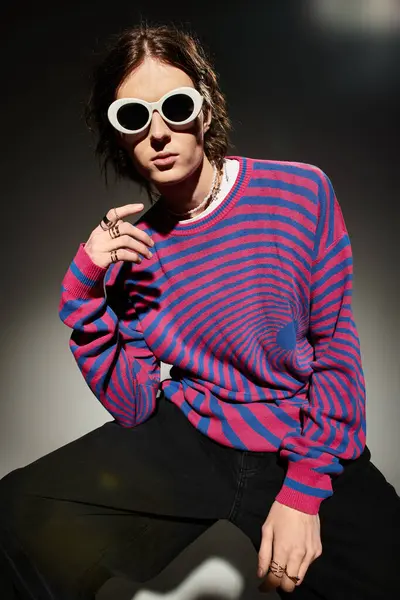 A handsome young man poses confidently in vibrant attire, exuding charm and style. — Stock Photo
