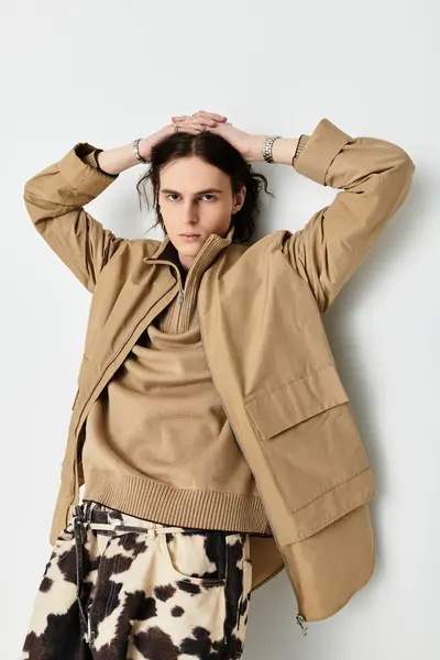 A handsome young man showcases his trendy outfit with a relaxed pose in a contemporary space. — Stock Photo