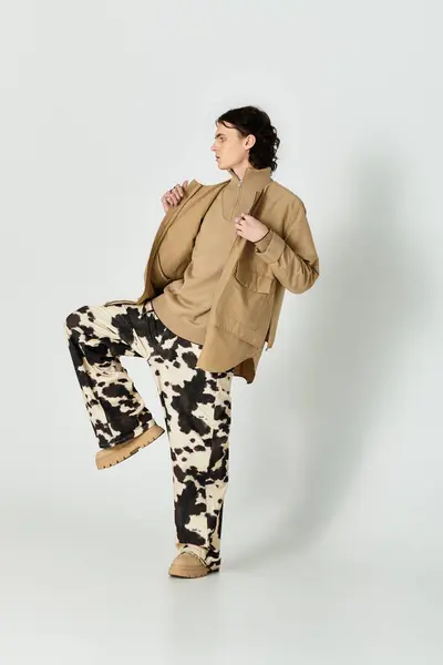 Handsome young man confidently showcases a contemporary fashion style in a modern setting. — Stock Photo
