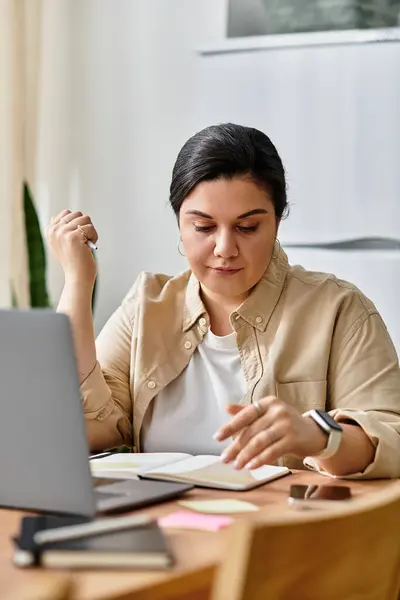 A beautiful plus sized woman thoughtfully writes notes at her desk, surrounded by a calm atmosphere. — Stock Photo