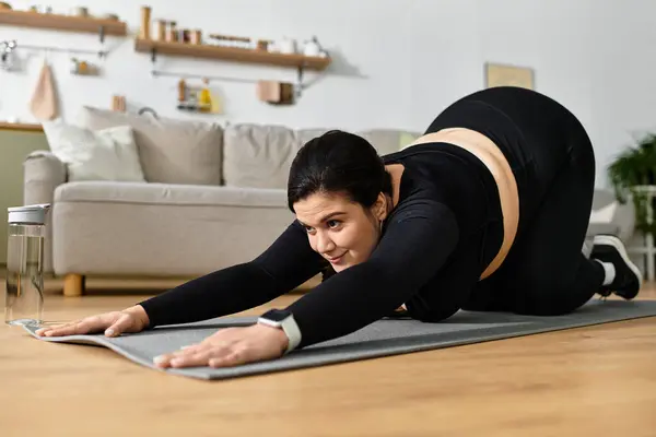 Young plus sized woman stretches in a cozy living room, embracing wellness and mindfulness. — Stock Photo