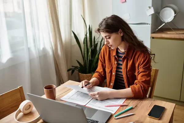 A young woman appears deep in thought, overwhelmed by her feelings while studying. — Stock Photo