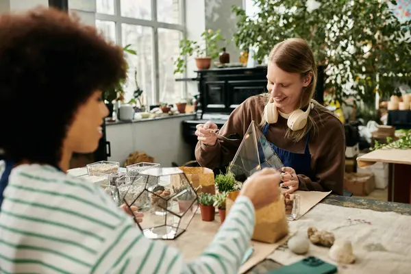 Two friends create beautiful terrariums while enjoying a colorful succulent workshop together. — Stock Photo